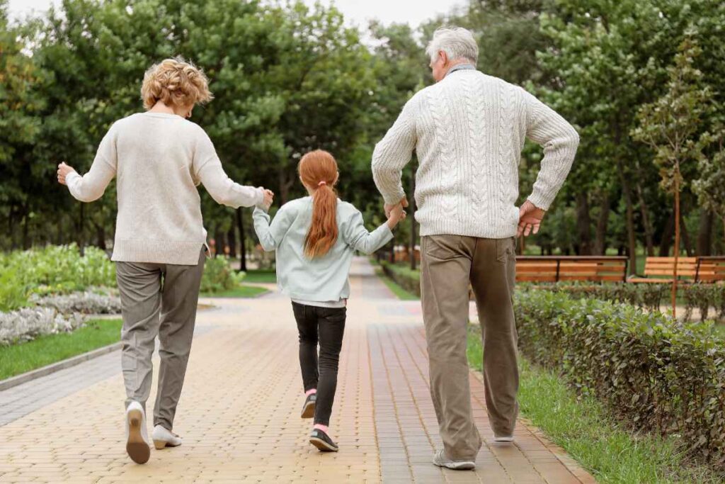 Three generations enjoying a walk in the city park. This is intended to represent the last of 6 spiritual practices that help improve your intuition.