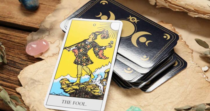 The Fool Tarot card, face up on top of a Tarot deck, symbolizing new beginnings, optimism, and personal growth.